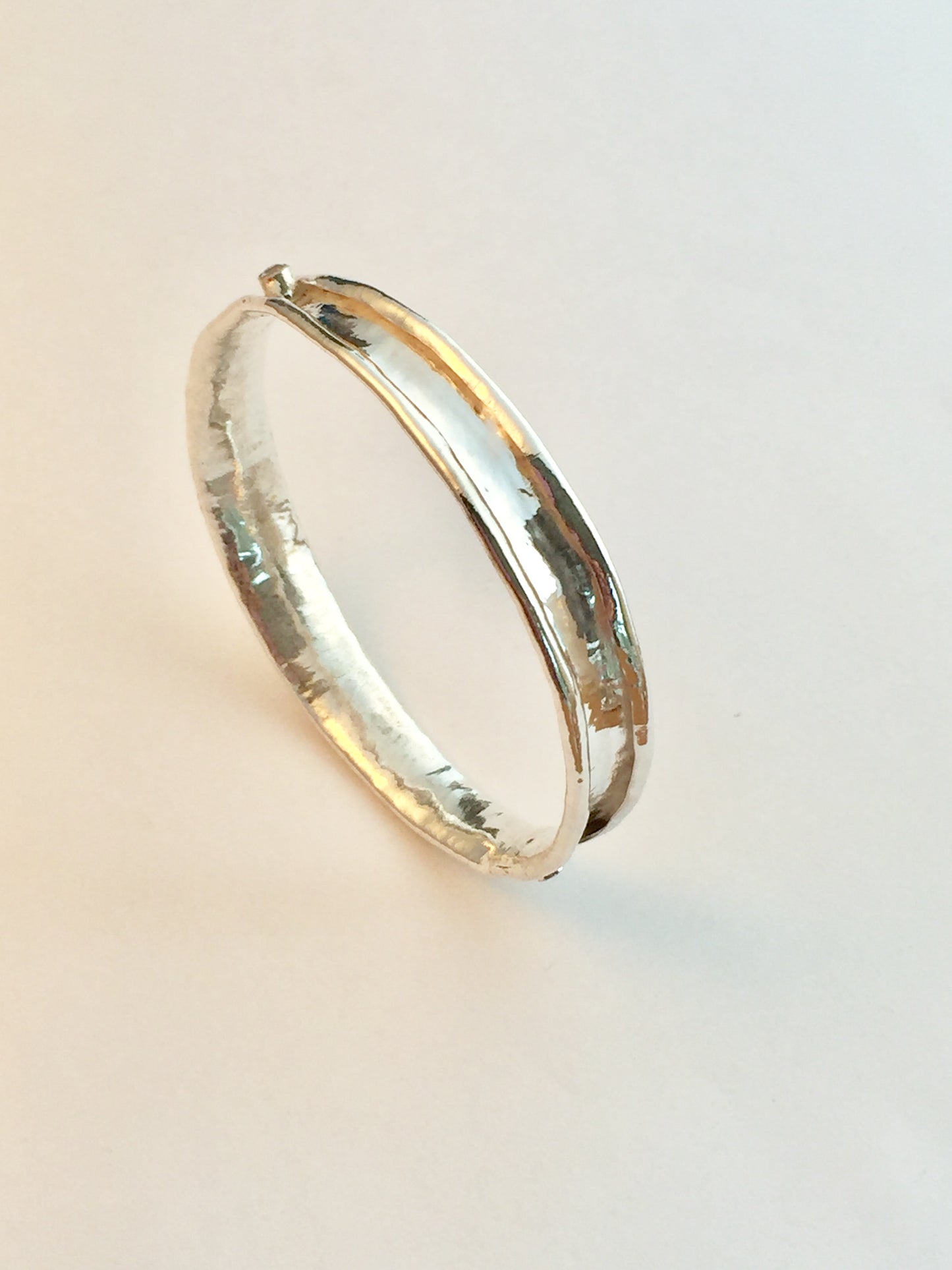 Sterling silver anticlastic bangle with white sapphire