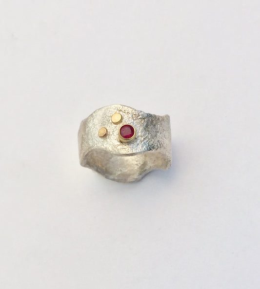 Silver, gold and ruby ring.