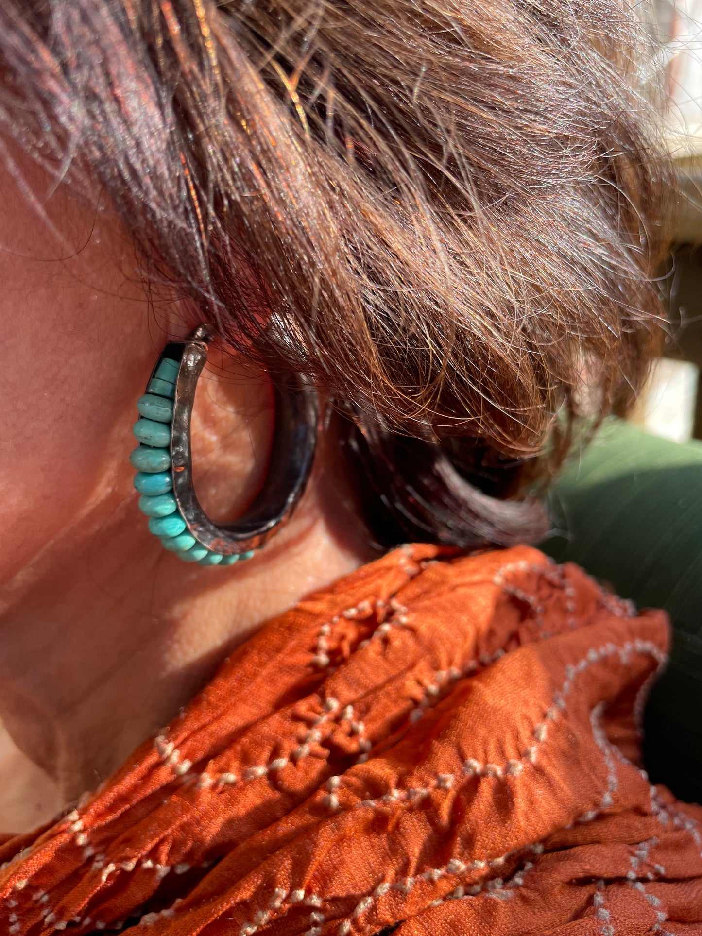 Oxidized sterling silver anticlastic hoop earrings with turquoise.