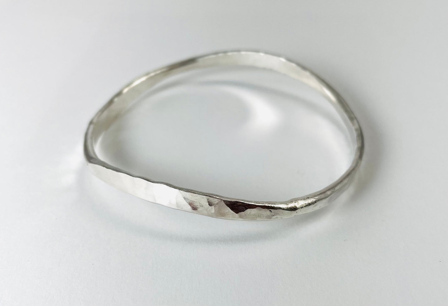 Sterling silver hand forged round bangle.