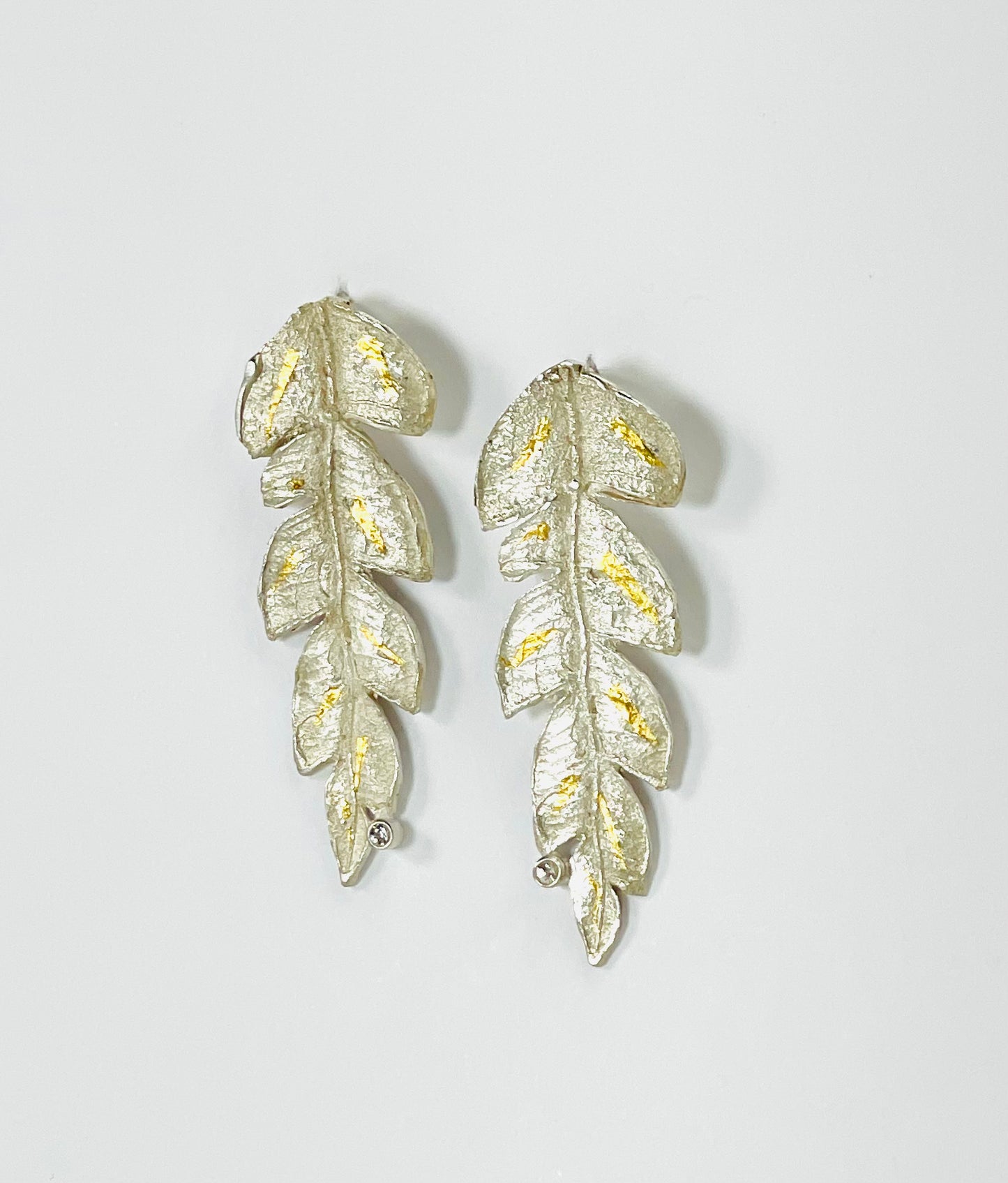 Sterling silver leaf earrings with 24K gold accents and white sapphires