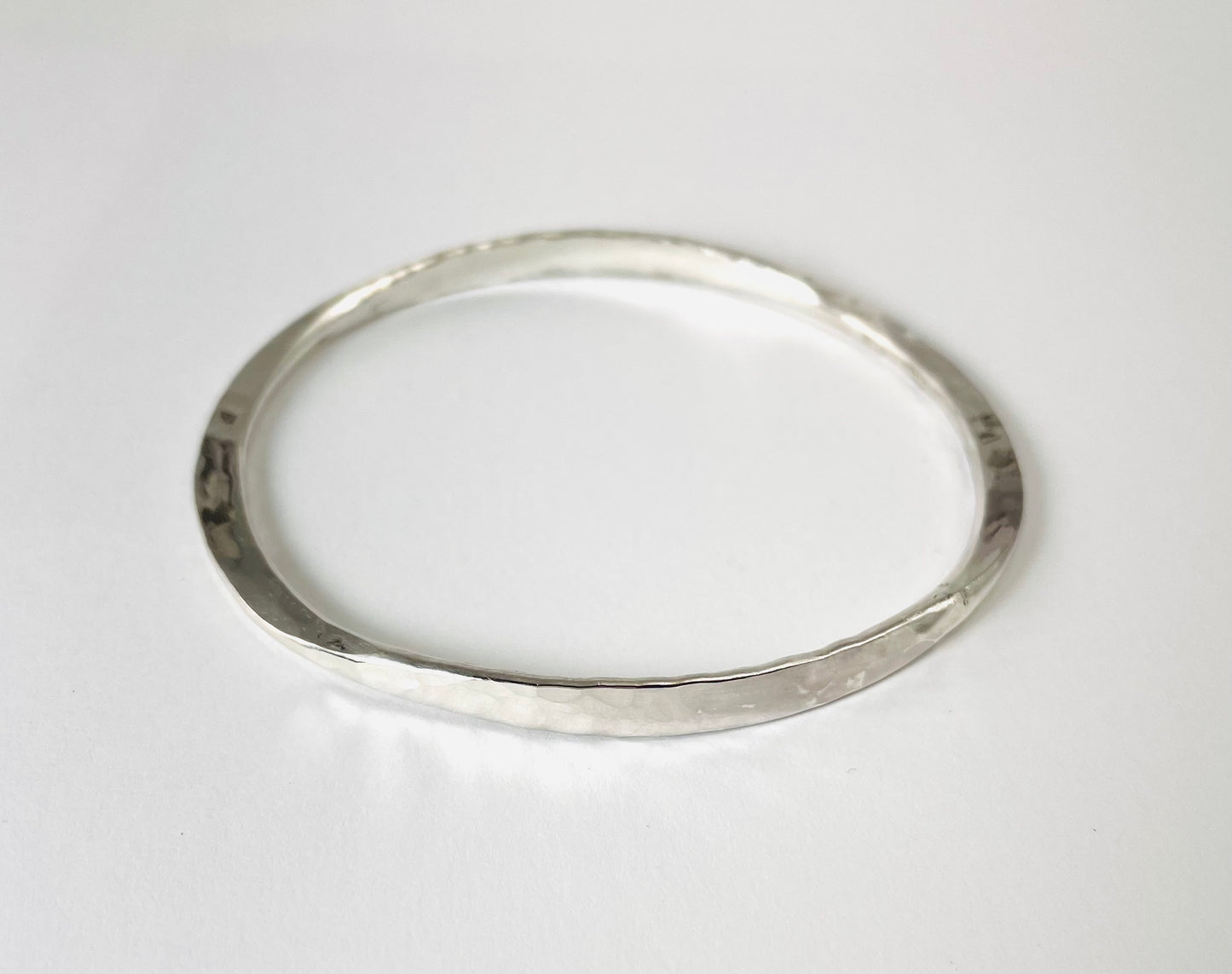 Sterling silver hand forged round bangle.