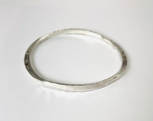 Sterling silver hand forged oval bangle.