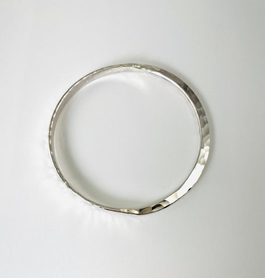 Sterling silver hand forged round bangle.
