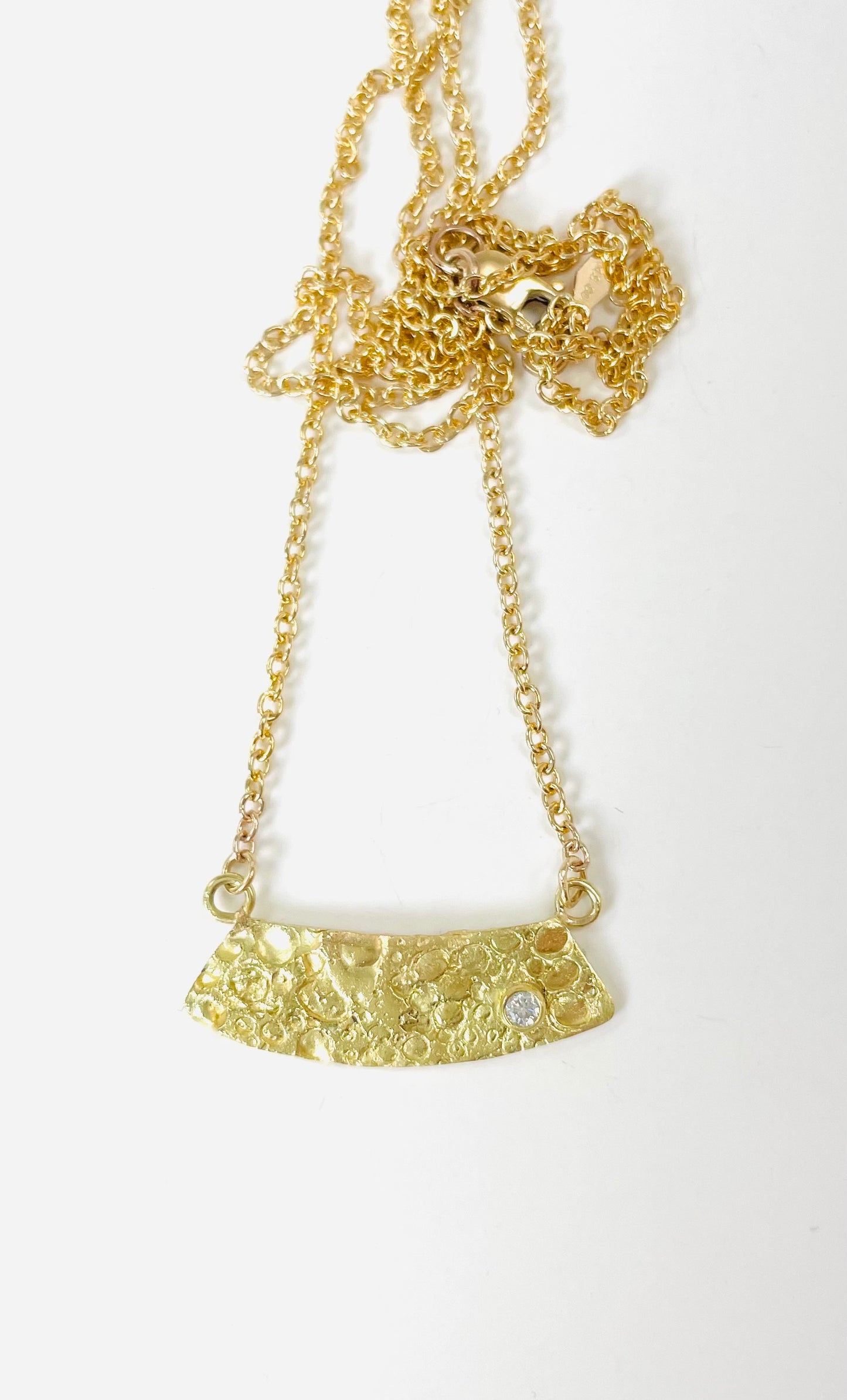 18K gold textured pendant with diamond