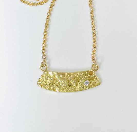18K gold textured pendant with diamond