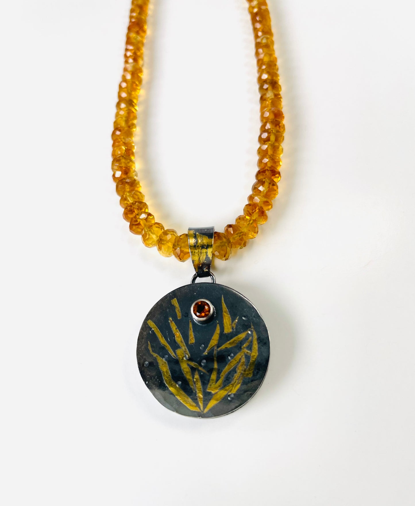 Faceted citrine bead necklace with a sterling silver/gold pendant