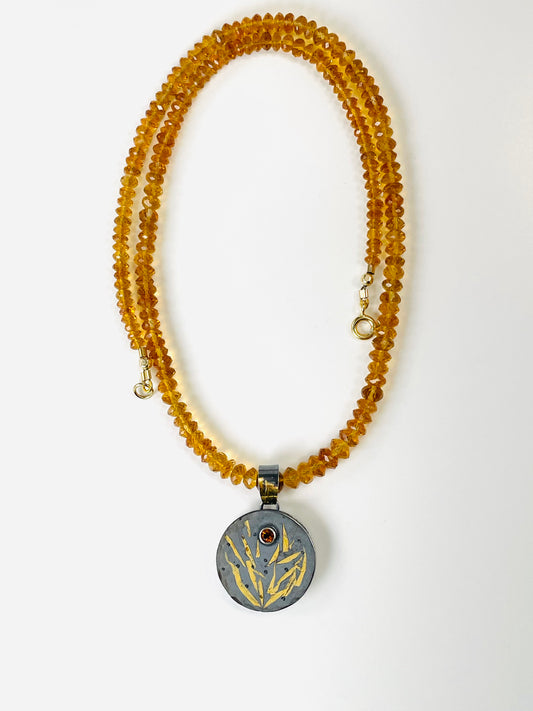 Faceted citrine bead necklace with a sterling silver/gold pendant