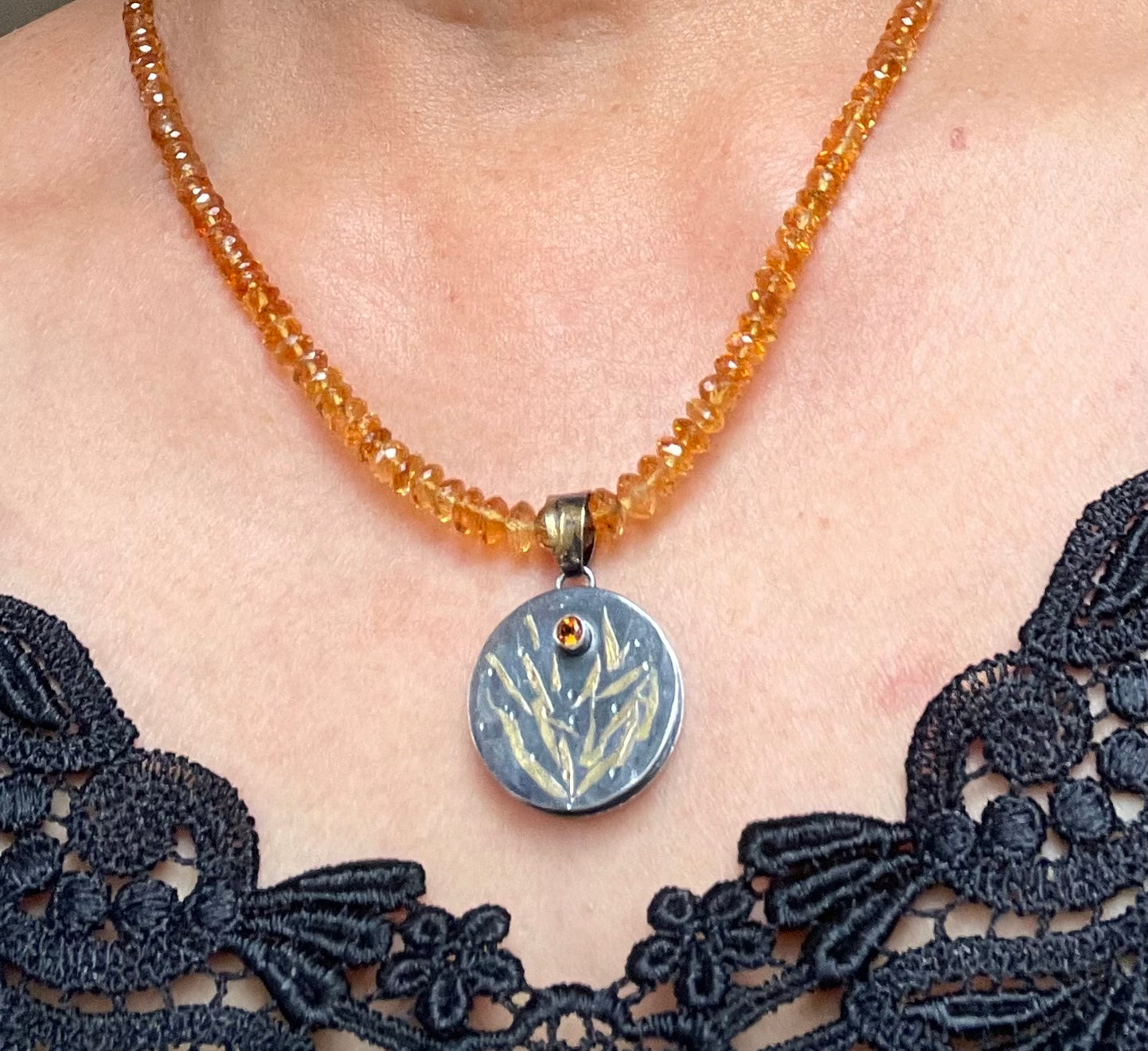 Faceted citrine bead necklace with a sterling silver/gold pendant