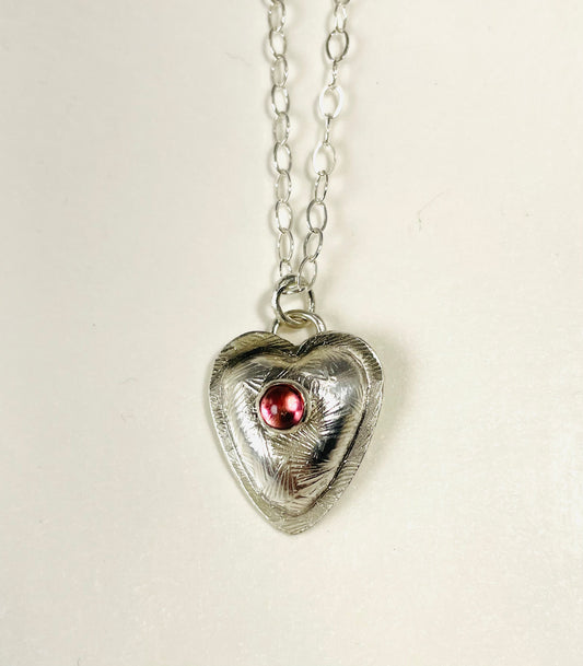 Sterling silver heart pendant with pink tourmaline.