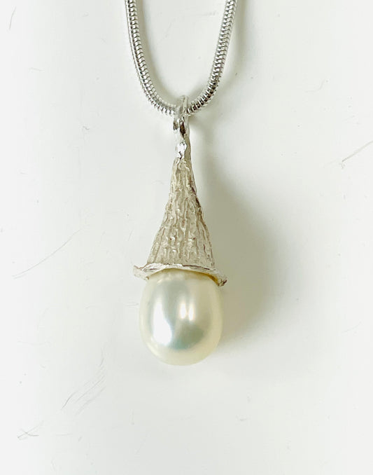 Fresh water tear drop pearl in a sterling silver textured cap.
