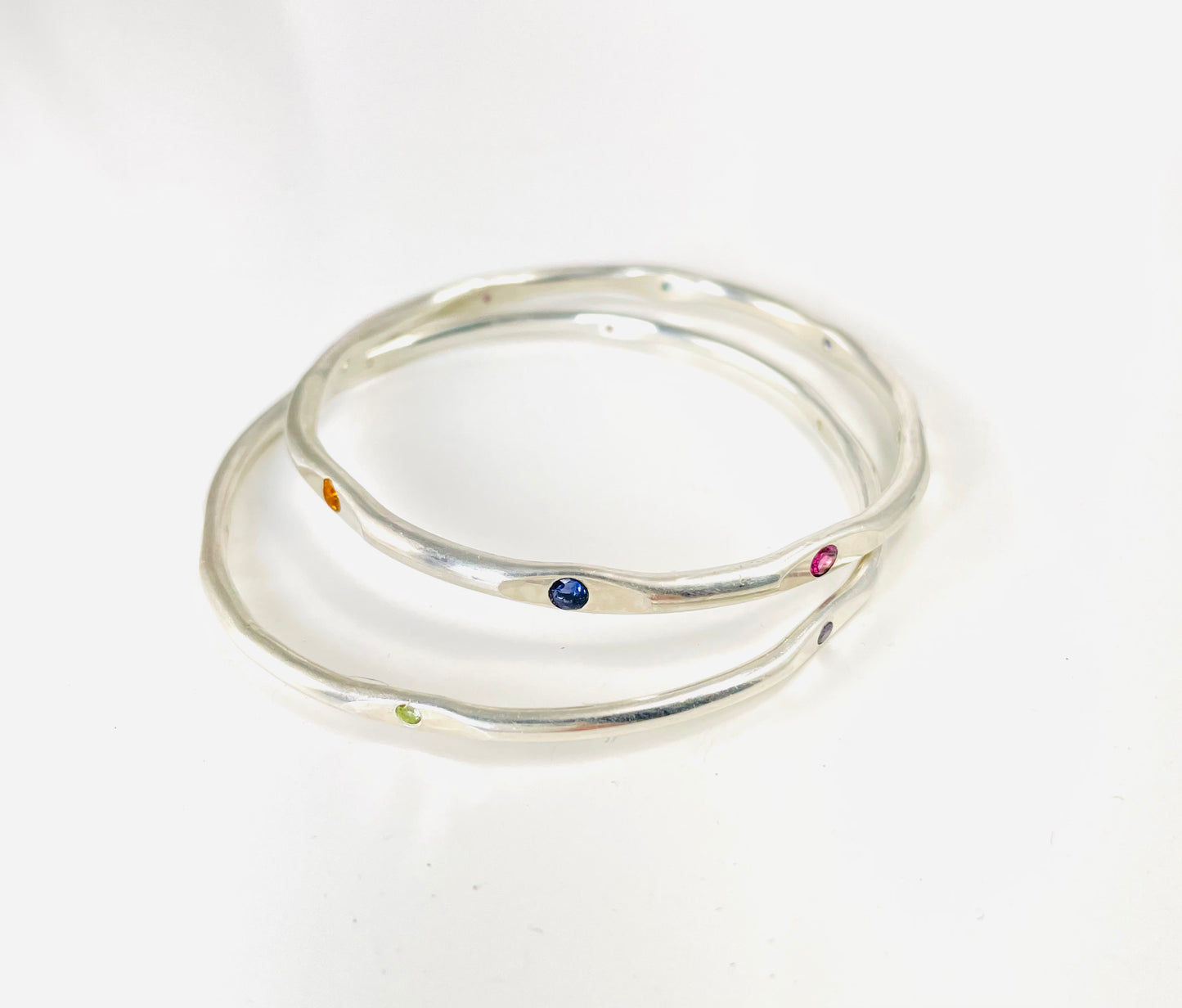 Sterling silver hand forged faceted bangle with 3mm gemstones.
