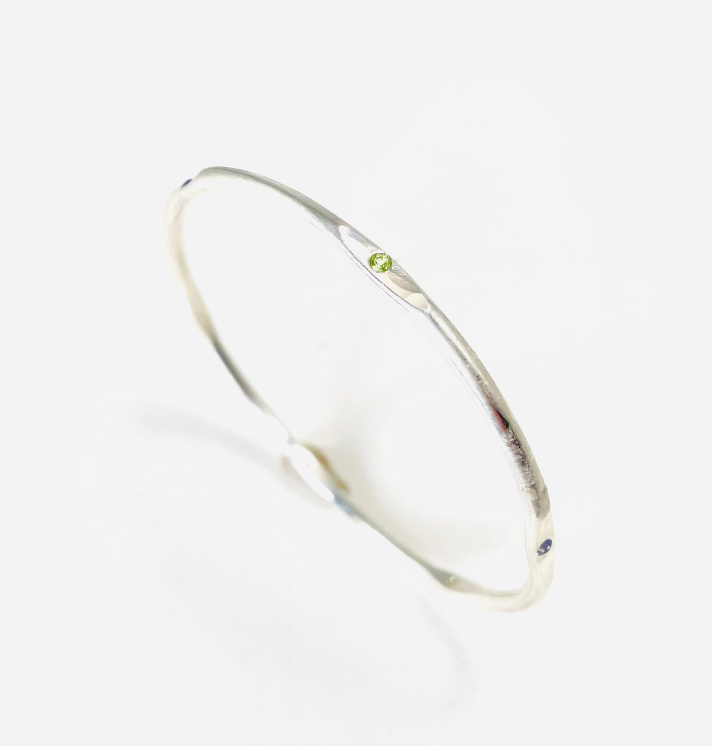 Sterling silver hand forged faceted bangle with 2mm gemstones.
