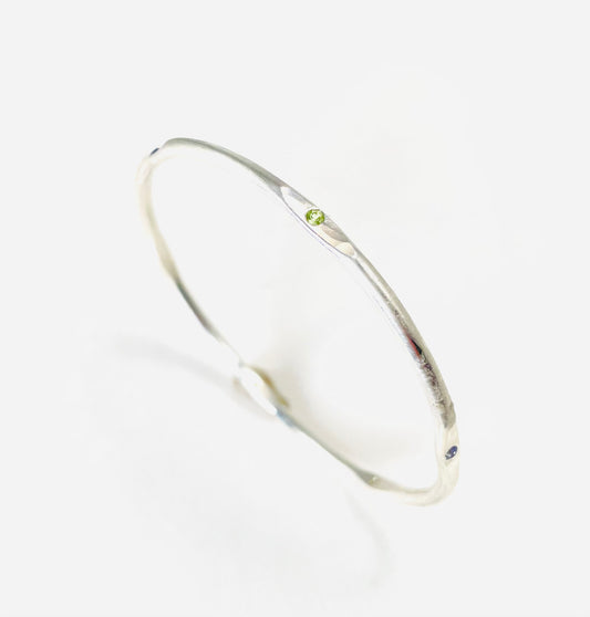 Sterling silver hand forged faceted bangle with 2mm gemstones.