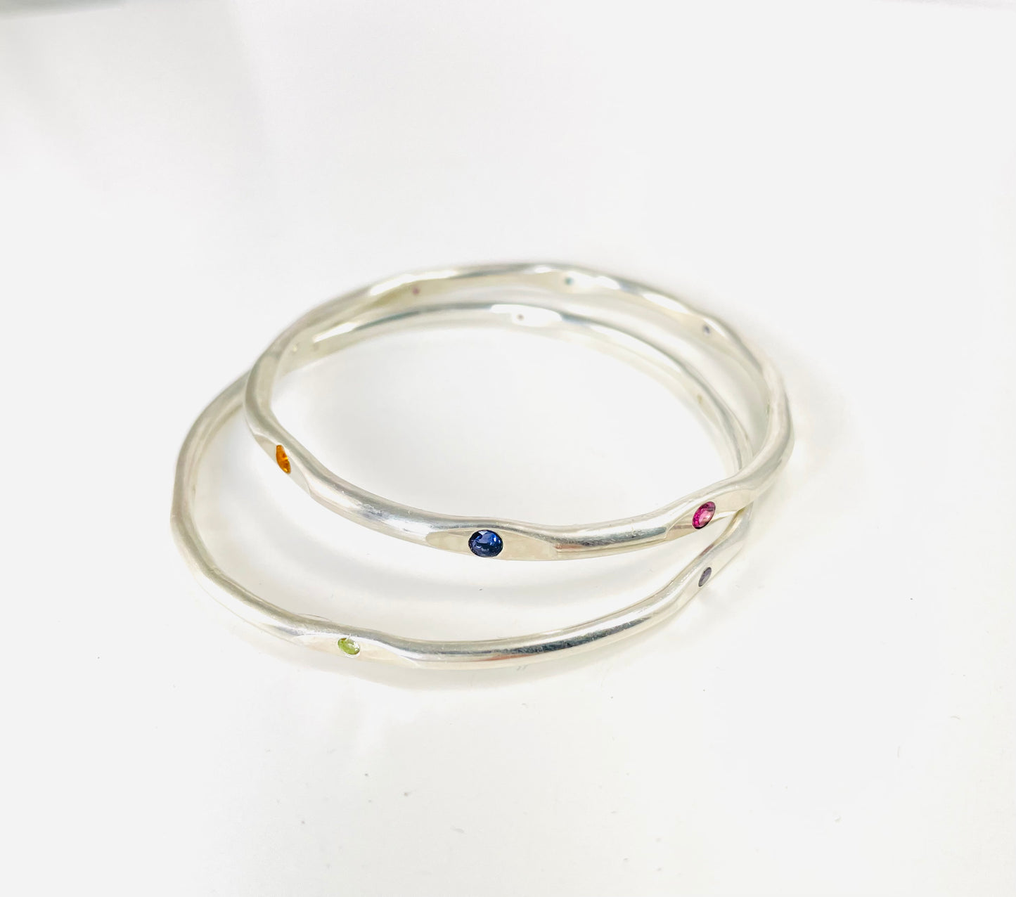 Sterling silver hand forged faceted bangle with 2mm gemstones.