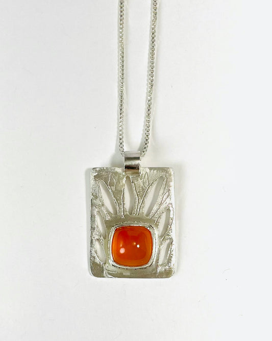 Sterling silver and carnelian pierced pendant.