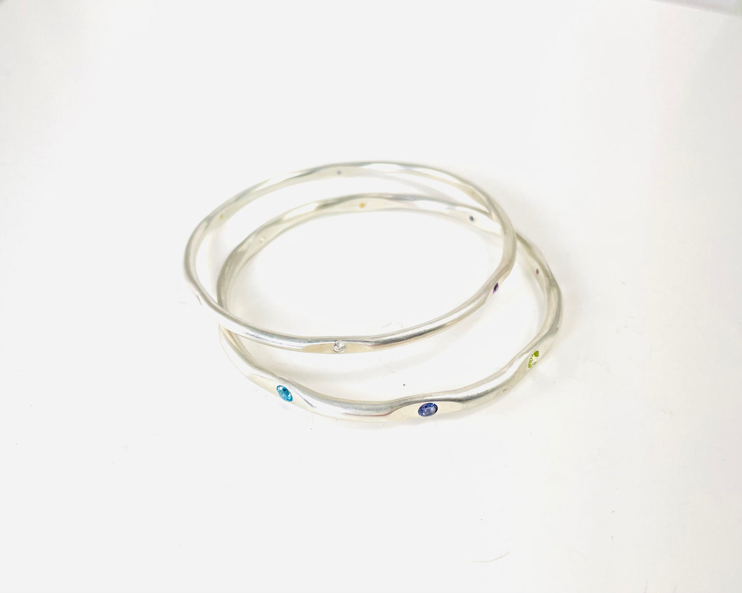 Sterling silver hand forged faceted bangle with 3mm gemstones.