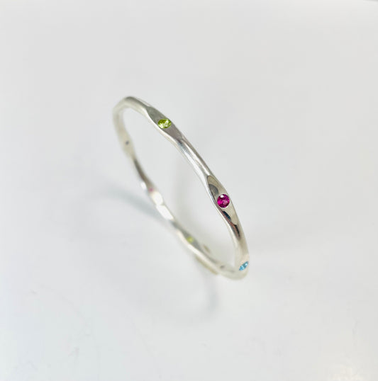 Sterling silver hand forged faceted bangle with 3mm gemstones.