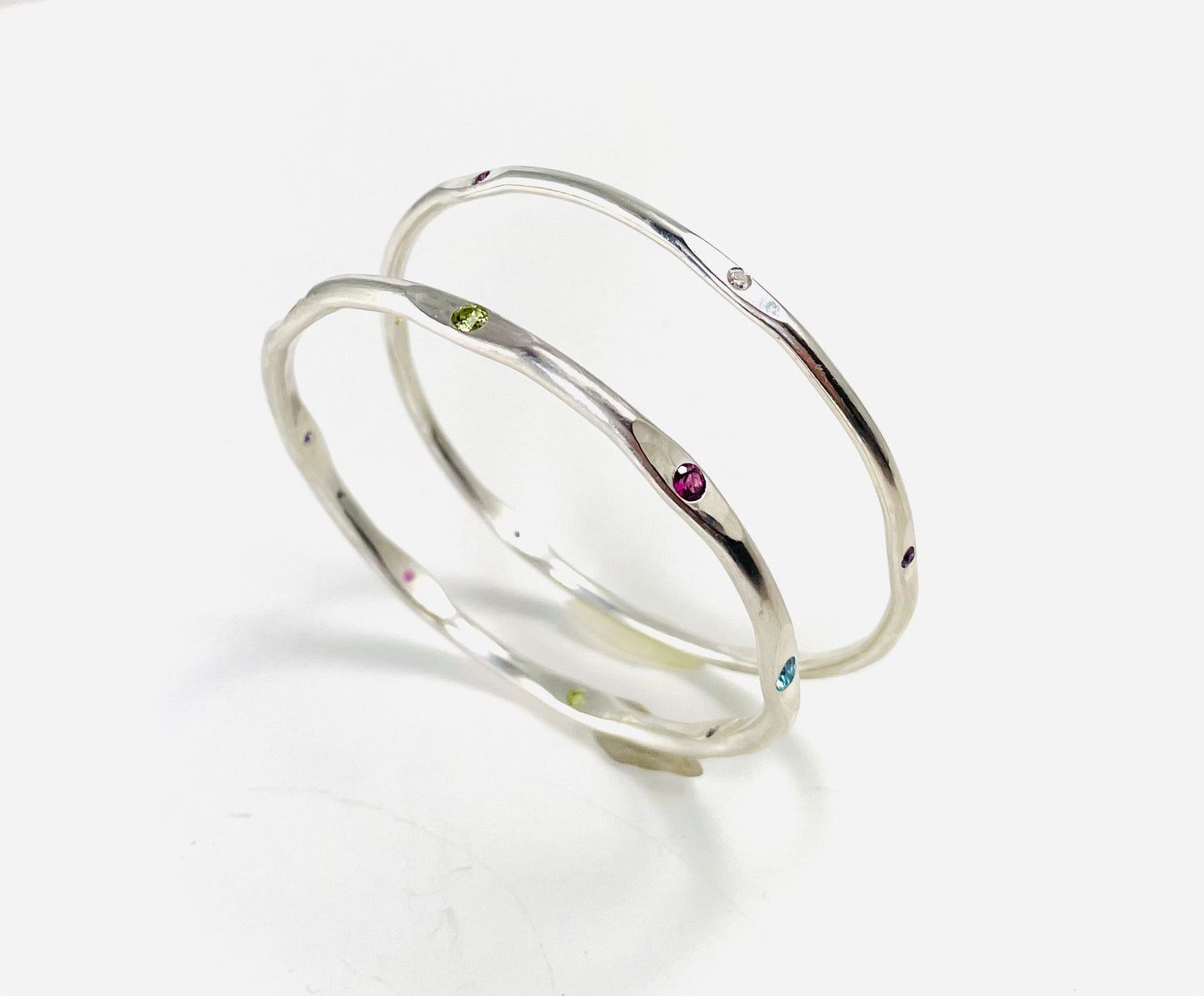 Sterling silver hand forged faceted bangle with 3mm gemstones.