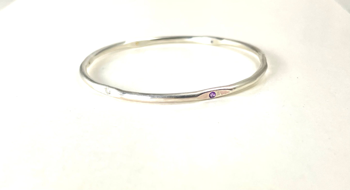 Sterling silver hand forged faceted bangle with 3mm gemstones.
