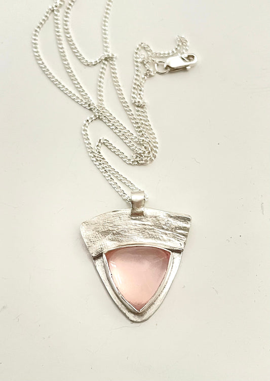 Sterling silver rose quartz pendant on a silver chain.
